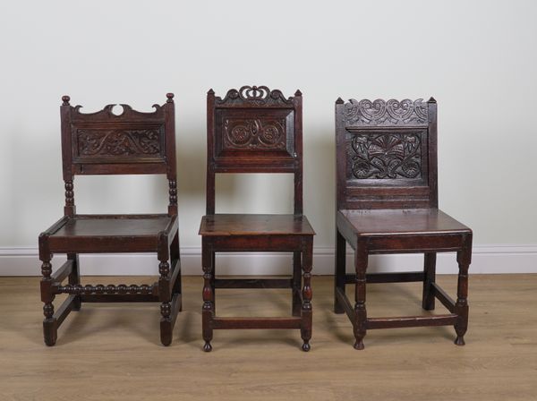 THREE VARIOUS CHARLES II CARVED OAK PANEL BACK CHAIRS (3)