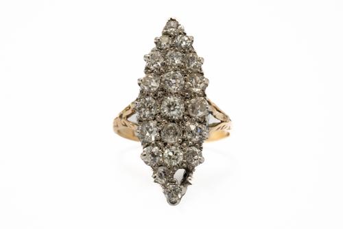 A GOLD AND DIAMOND MARQUISE SHAPED CLUSTER RING