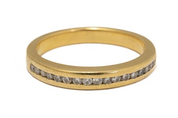 A GOLD AND DIAMOND HALF ETERNITY RING