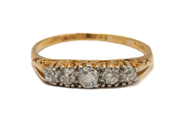 A GOLD AND DIAMOND FIVE STONE RING