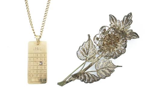 A 9CT GOLD AND DIAMOND SET DATE OF BIRTH CALENDAR PENDANT WITH A NECKCHAIN AND A BROOCH (3)