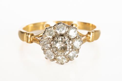 A GOLD AND DIAMOND NINE STONE CLUSTER RING