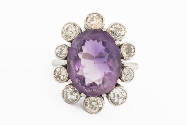 A WHITE GOLD, AMETHYST AND DIAMOND OVAL CLUSTER RING