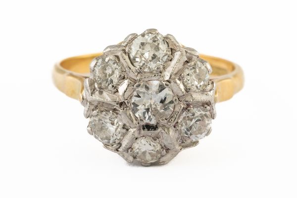 A GOLD AND PLATINUM, DIAMOND SEVEN STONE CLUSTER RING