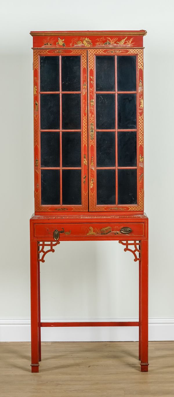 AN EARLY 20TH CENTURY RED CHINOISERIE DECORATED TWO DOOR CABINET ON STAND