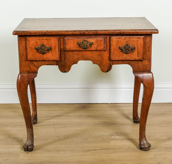 A GEORGE II WALNUT THREE DRAWER LOW BOY