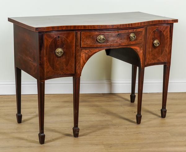 A GEORGE III INLAID MAHOGANY SERPENTINE THREE DRAWER SIDEBOARD