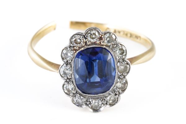 A GOLD AND PLATINUM, SYNTHETIC SAPPHIRE AND DIAMOND OVAL CLUSTER RING