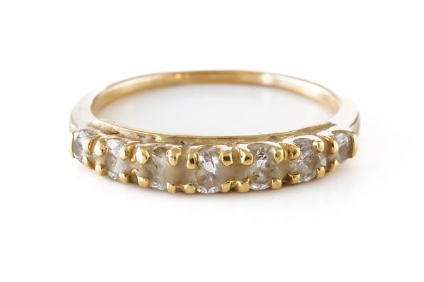 A GOLD AND DIAMOND SEVEN STONE HALF ETERNITY RING