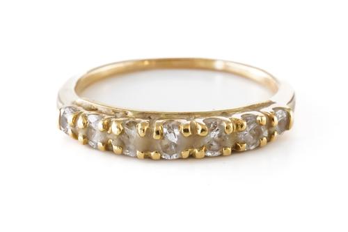 WITHDRAWN A GOLD AND DIAMOND SEVEN STONE HALF ETERNITY RING