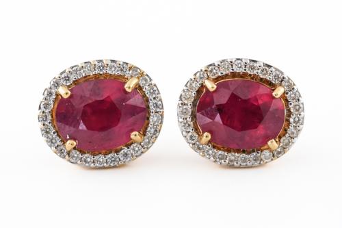 A PAIR OF GOLD, DIAMOND AND RUBY SET OVAL CLUSTER EARSTUDS