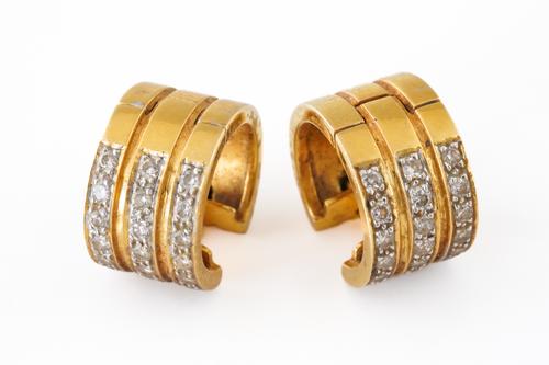 A PAIR OF GOLD AND DIAMOND EARCLIPS
