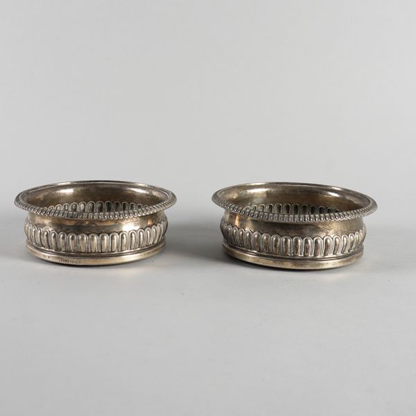 A PAIR OF GEORGE III SILVER MOUNTED BOTTLE COASTERS (2)