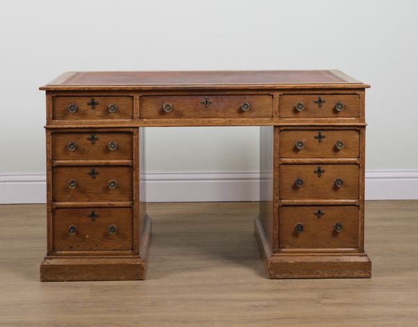 A VICTORIAN OAK NINE DRAWER PEDESTAL DESK