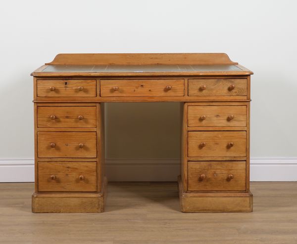 A VICTORIAN PINE KNEEHOLE NINE DRAWER WRITING DESK