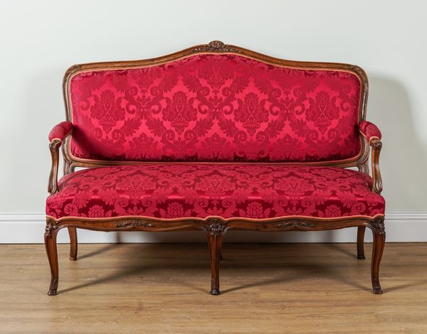 A LOUIS XV STYLE CARVED MAHOGANY OPEN ARM SETTEE