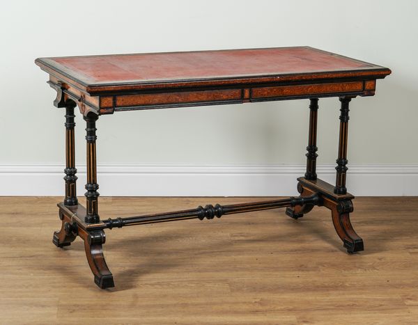 GILLOW AND CO; A MID 19TH CENTURY PARCEL GILT AMBOYNA AND EBONISED RECTANGULAR TWO DRAWER CENTRE WRITING TABLE