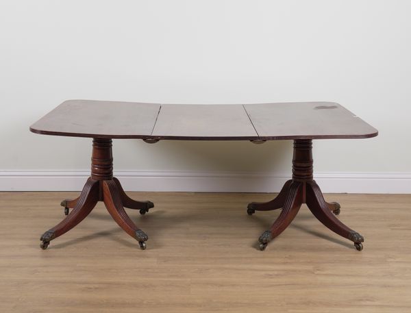 A GEORGE III MAHOGANY TWIN PEDESTAL EXTENDING DINING TABLE