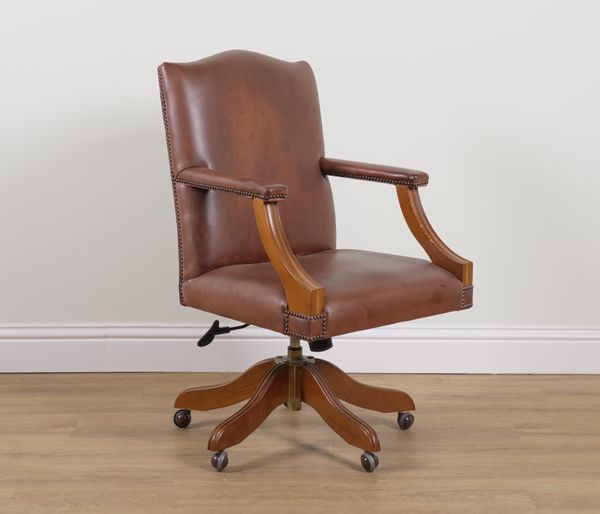 A BROWN LEATHER REVOLVING DESK CHAIR