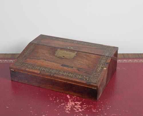 A VICTORIAN BRASS INLAID ROSEWOOD SLOPE FRONTED WRITING BOX