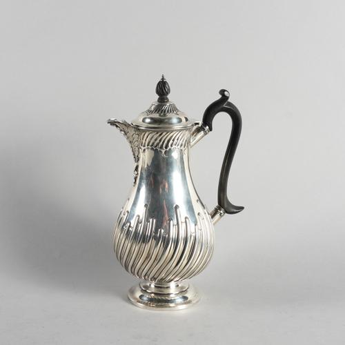 A LATE VICTORIAN SILVER HOT WATER JUG