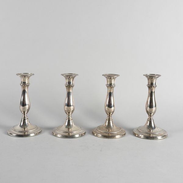 A SET OF FOUR GEORGE III SILVER CANDLESTICKS (4)