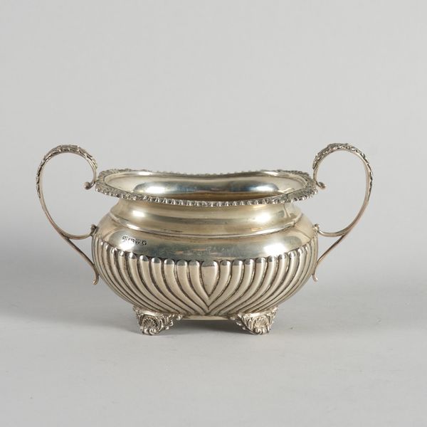 A SILVER TWIN HANDLED SUGAR BOWL