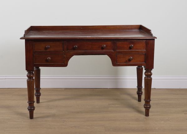 A VICTORIAN MAHOGANY FIVE DRAWER WRITING DESK