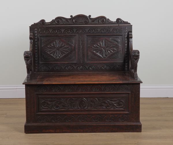 A VICTORIAN CARVED OAK DOUBLE PANEL BACK BOX SEAT SETTLE