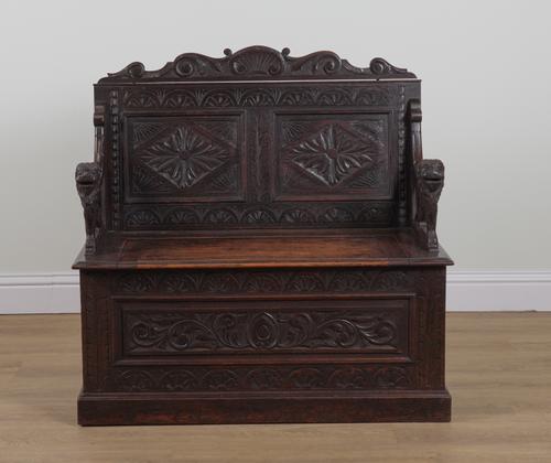 A VICTORIAN CARVED OAK DOUBLE PANEL BACK BOX SEAT SETTLE