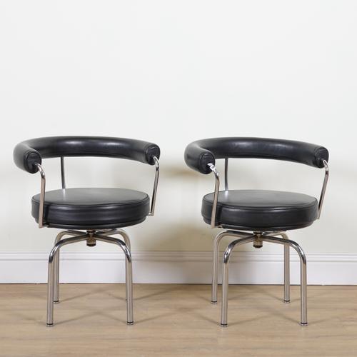 AFTER LE CORBUSIER; A PAIR OF LC7 SWIVEL ARMCHAIRS (2)