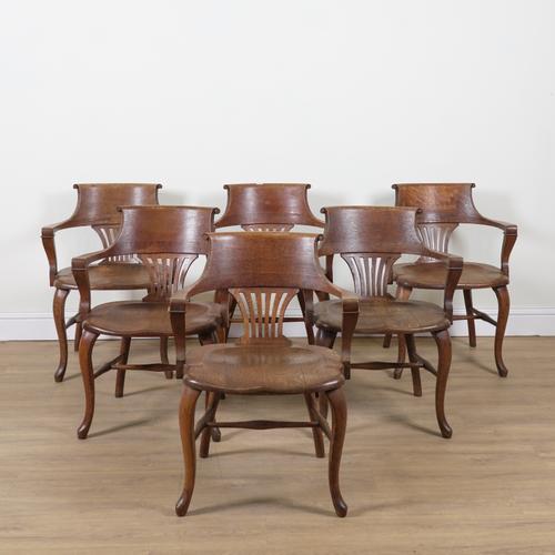 A SET OF SIX EDWARDIAN OAK OPEN ARM DESK CHAIRS (6)