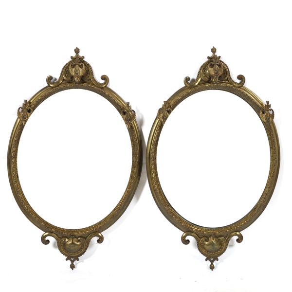 A PAIR OF VICTORIAN GILT BRONZE OVAL SHAPED MIRRORS (2)