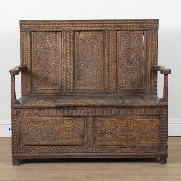 A LATE 18TH CENTURY CARVED OAK BOX SEAT SETTLE