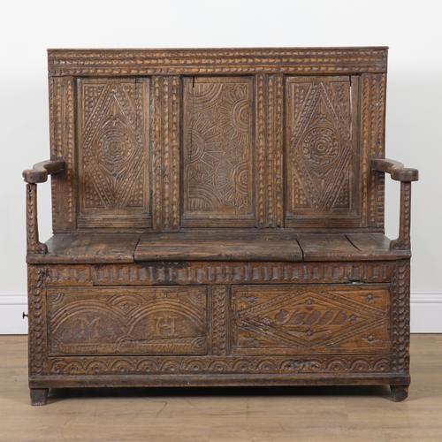 A LATE 18TH CENTURY CARVED OAK BOX SEAT SETTLE