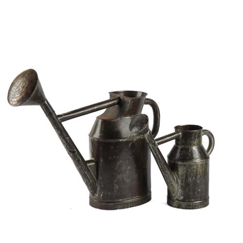 AN OVERSIZED METAL WATERING CAN AND ANOTHER SMALLER CAN (2)