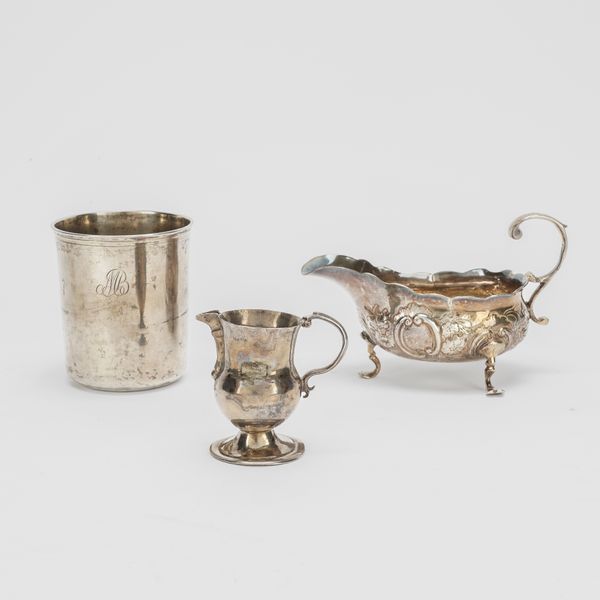 A SILVER SAUCEBOAT, A SMALL CREAM JUG AND A EUROPEAN BEAKER (3)