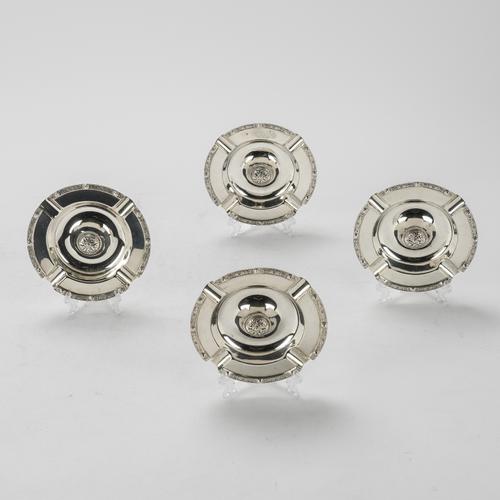 A SET OF FOUR SILVER ASHTRAYS (4)