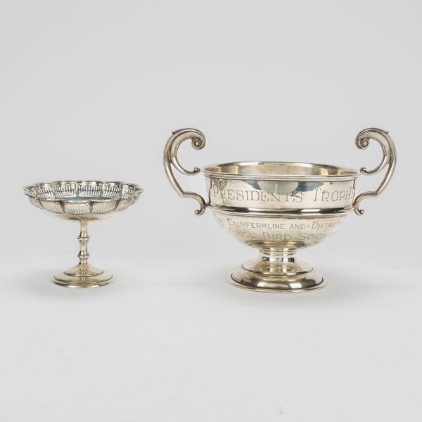 A SILVER TWIN HANDLED TROPHY AND A SILVER PEDESTAL BONBON DISH (2)