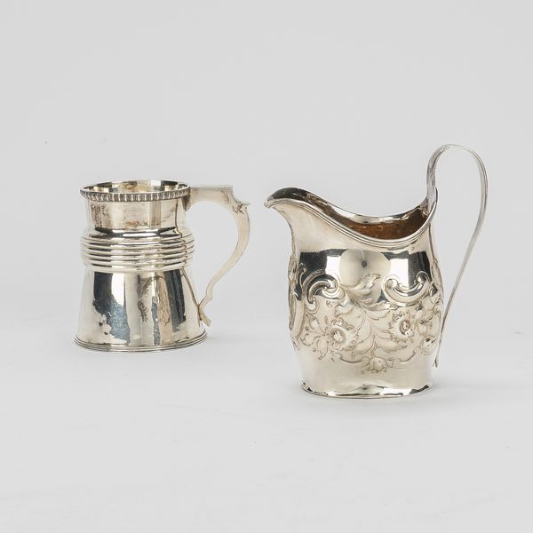 A SILVER HELMET SHAPED MILK JUG AND A SILVER CHRISTENING MUG (2)