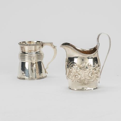 A SILVER HELMET SHAPED MILK JUG AND A SILVER CHRISTENING MUG (2)