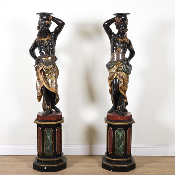 A PAIR OF LATE 19TH CENTURY VENETIAN CARVED AND POLYCHROME PAINTED MOORE FIGURAL TORCHERE STANDS (2)