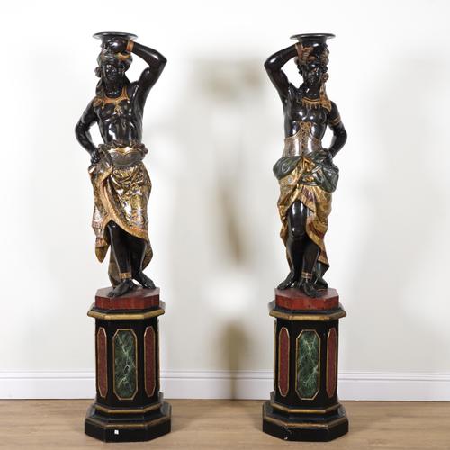 A PAIR OF LATE 19TH CENTURY VENETIAN CARVED AND POLYCHROME PAINTED MOORE FIGURAL TORCHERE STANDS (2)