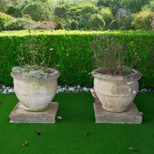 A PAIR OF RECONSTITUTED STONE CIRCULAR PLANTERS (2)