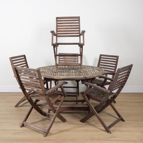 A STAINED HARDWOOD CIRCULAR TABLE AND SIX FOLDING CHAIRS (7)