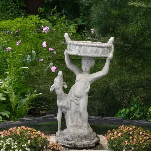 A RECONSTITUTED STONE FIGURE GROUP OF A BOY WITH A BASKET AND DOG