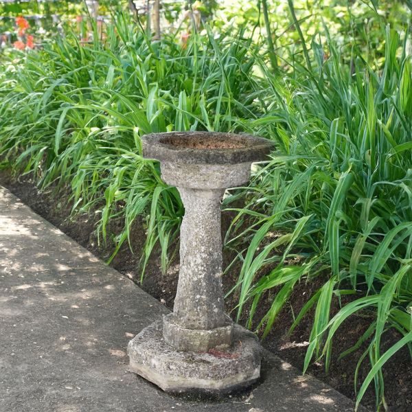 A CARVED STONE OCTAGONAL BIRD BATH