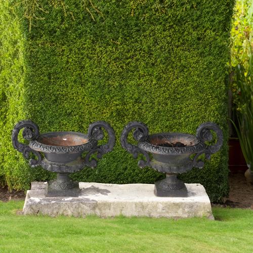 A PAIR OF EARLY 20TH CENTURY BLACK PAINTED CAST IRON JARDINIERES (2)