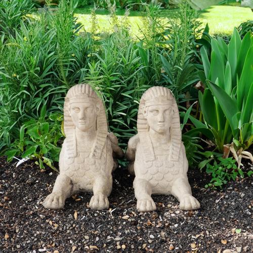 A PAIR OF EGYPTIAN REVIVAL STONE EFFECT RECLINING SPHYNXES (2)