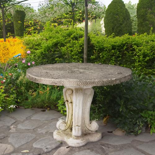 A RECONSTITUTED STONE CIRCULAR TABLE
